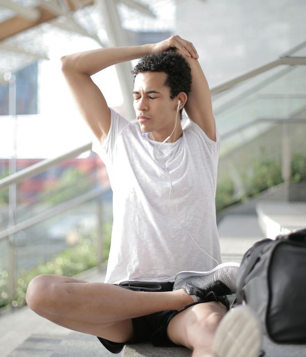 Man meditating in a calm environment, with soft light focusing on his posture.
